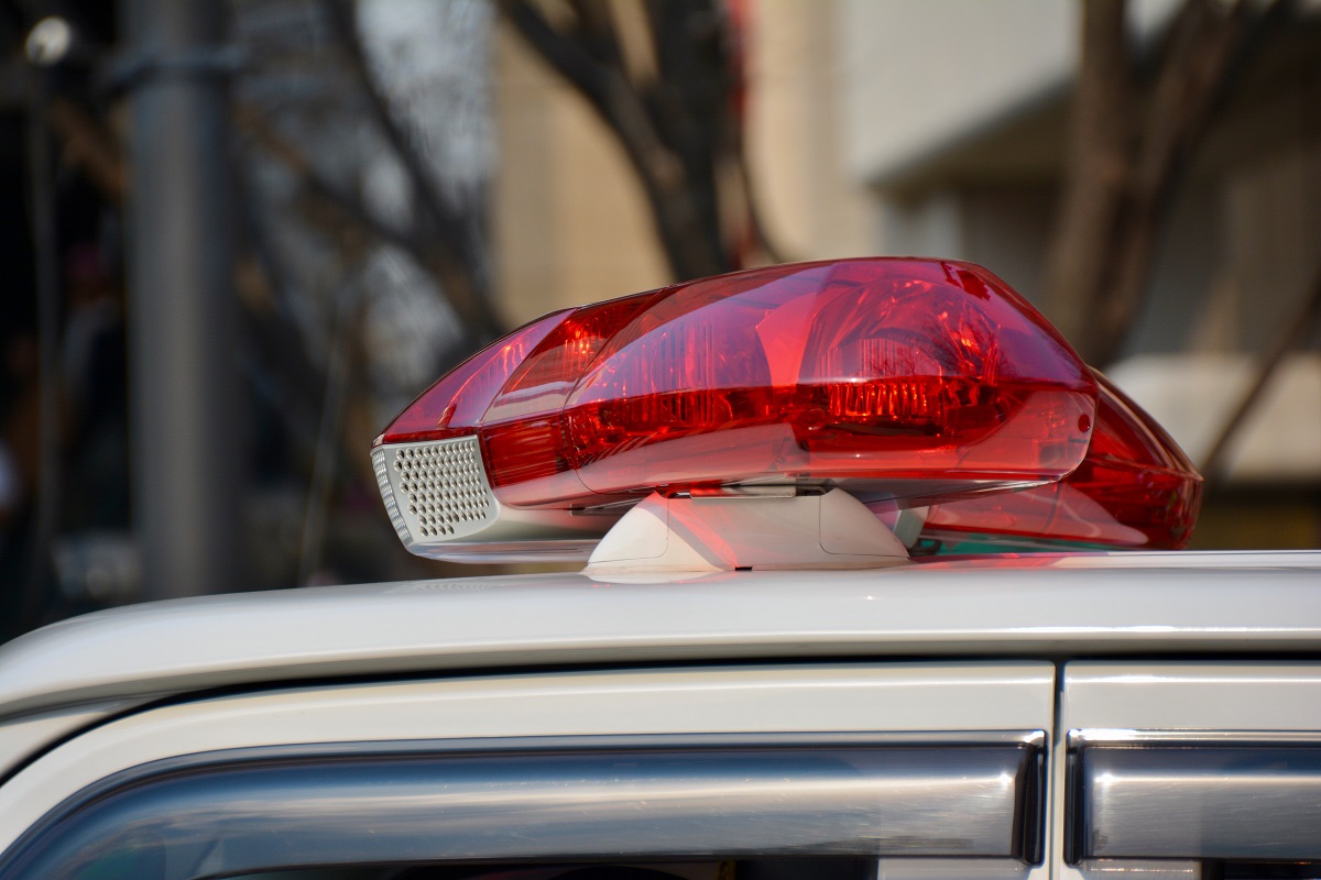 A closeup of the red light on top of a police vehicle.