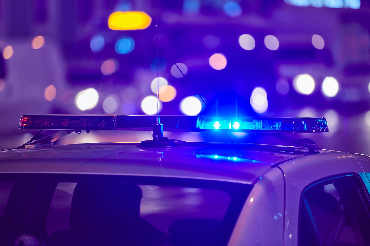 A police car at night with the blue light on.