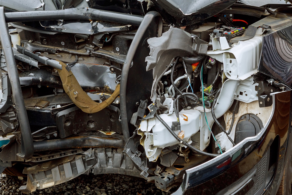 The exposed and damaged mechanical parts of a crashed car.