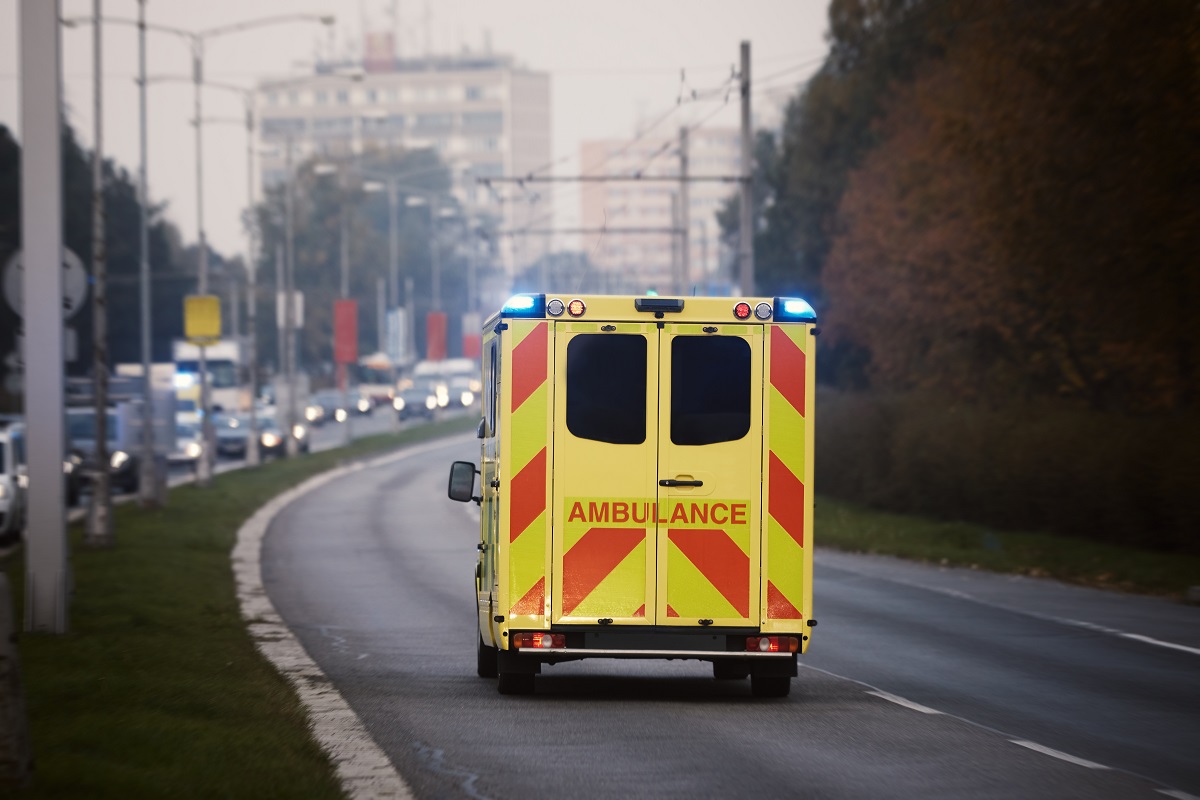 An ambulance driving away.