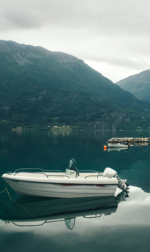 A white boat sits in the middle of a body of water.
