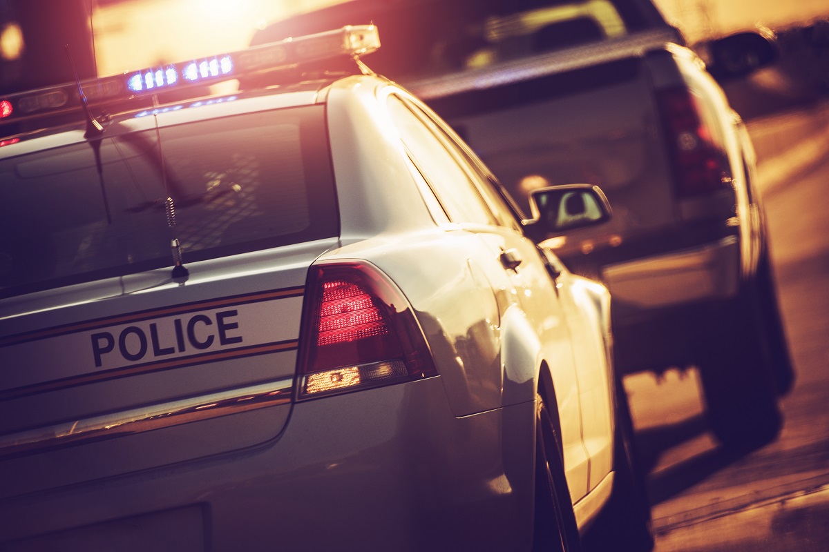 A police car with its lights engages.