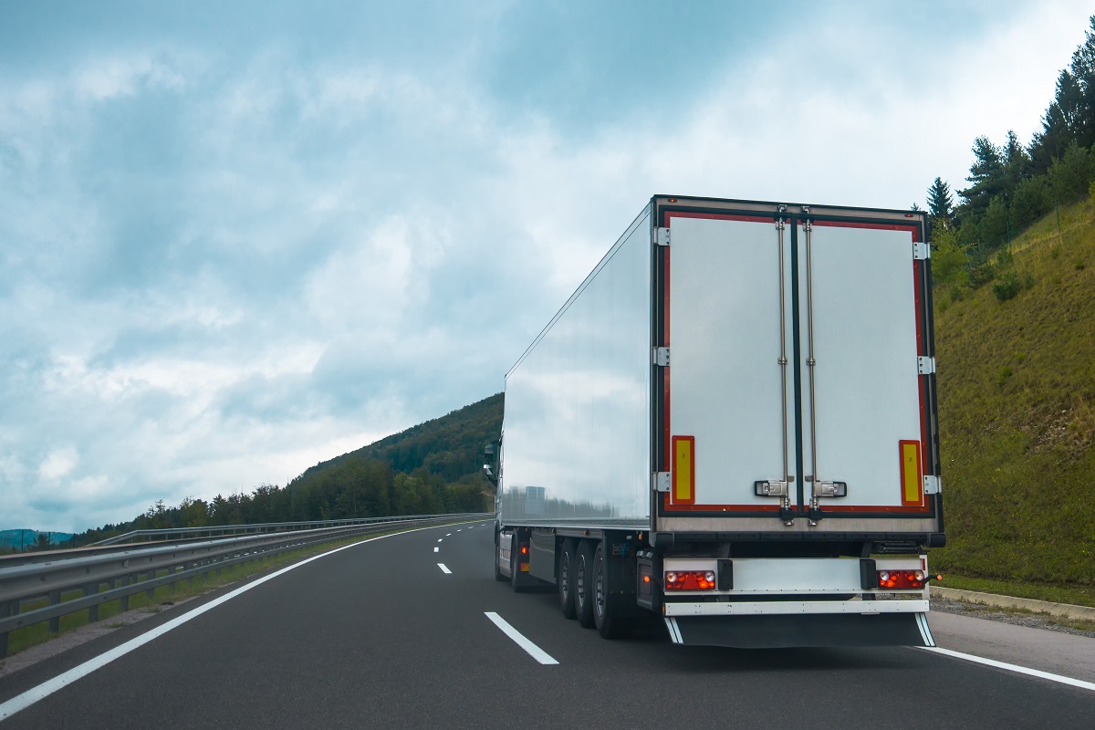 A semi-truck driving on the highway.